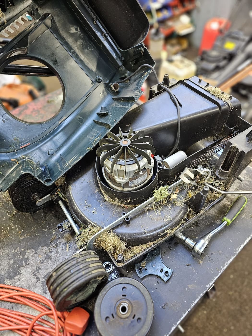 Grass build-up around the exposed motor of a Hayter Envoy