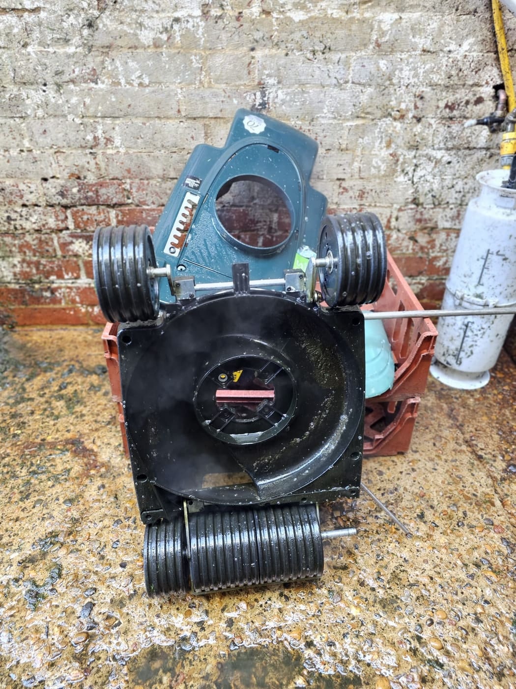 A washed Hayter Envoy deck and wheels drying in the yard