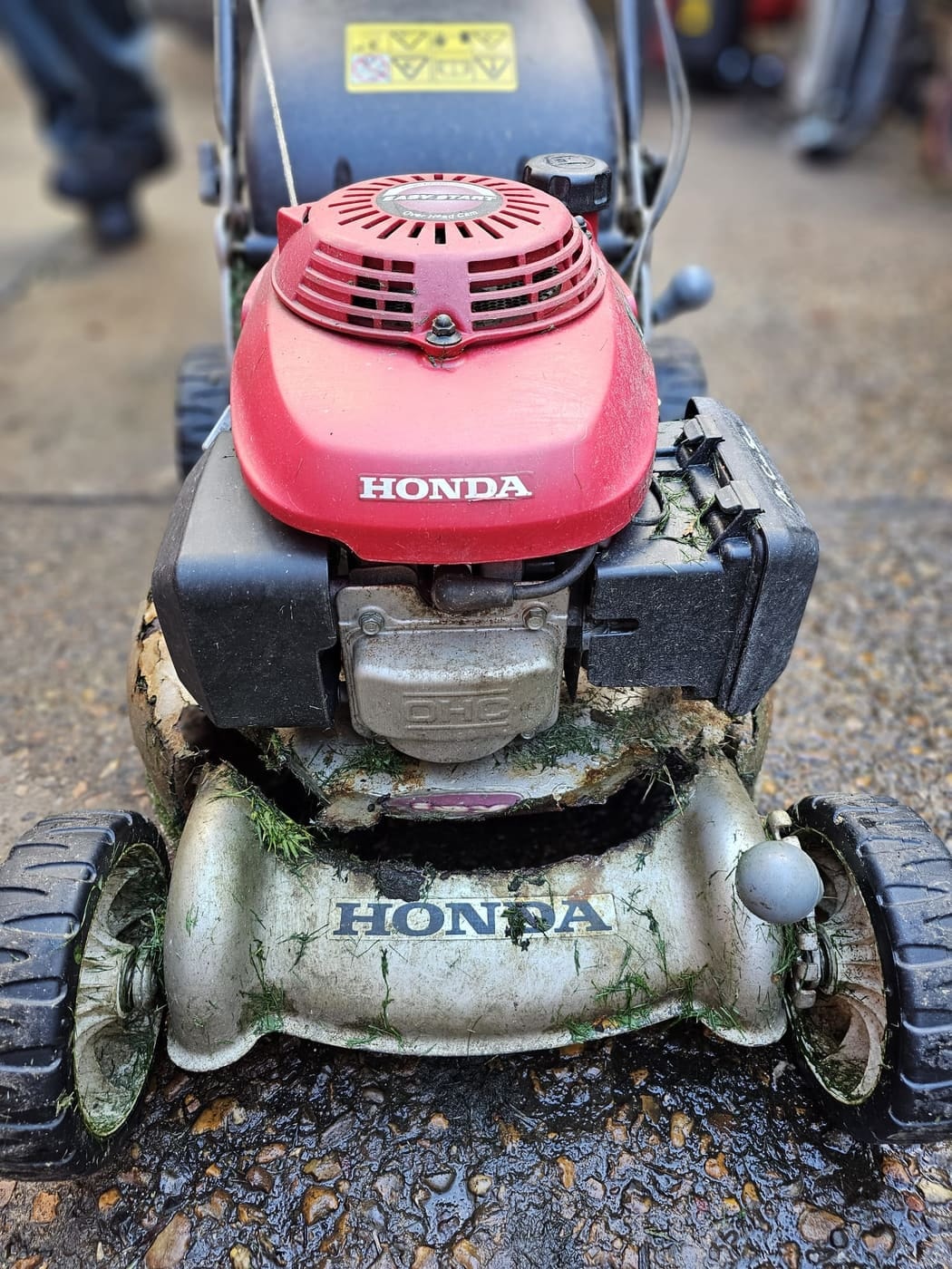 A Honda mower whose steel deck has rusted through and split
