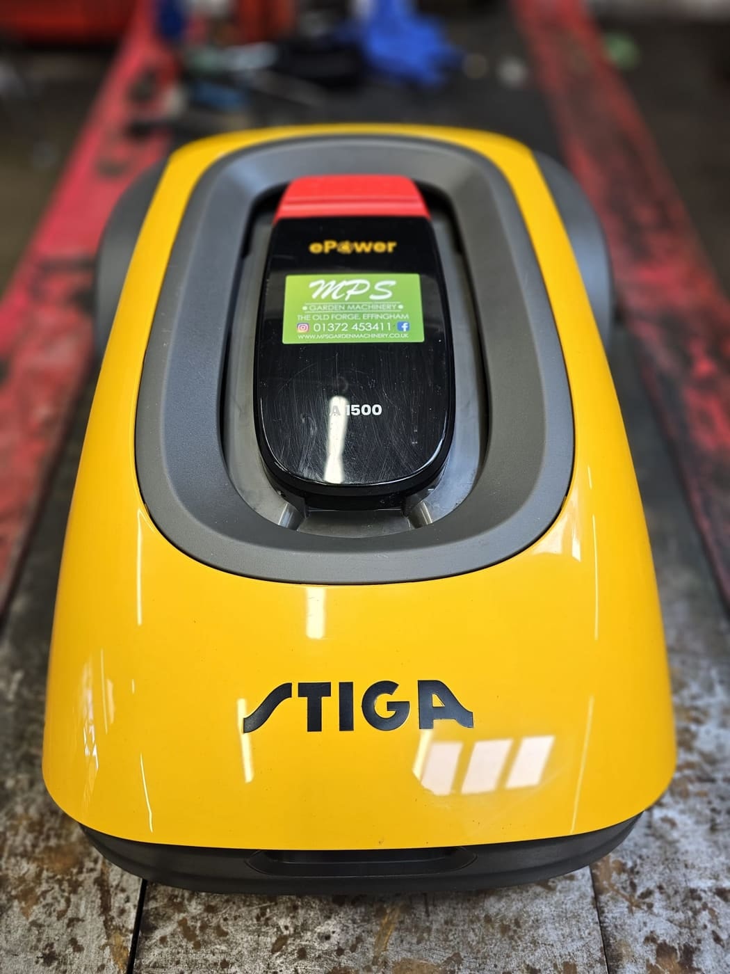 A Stiga robot mower on the workshop bench