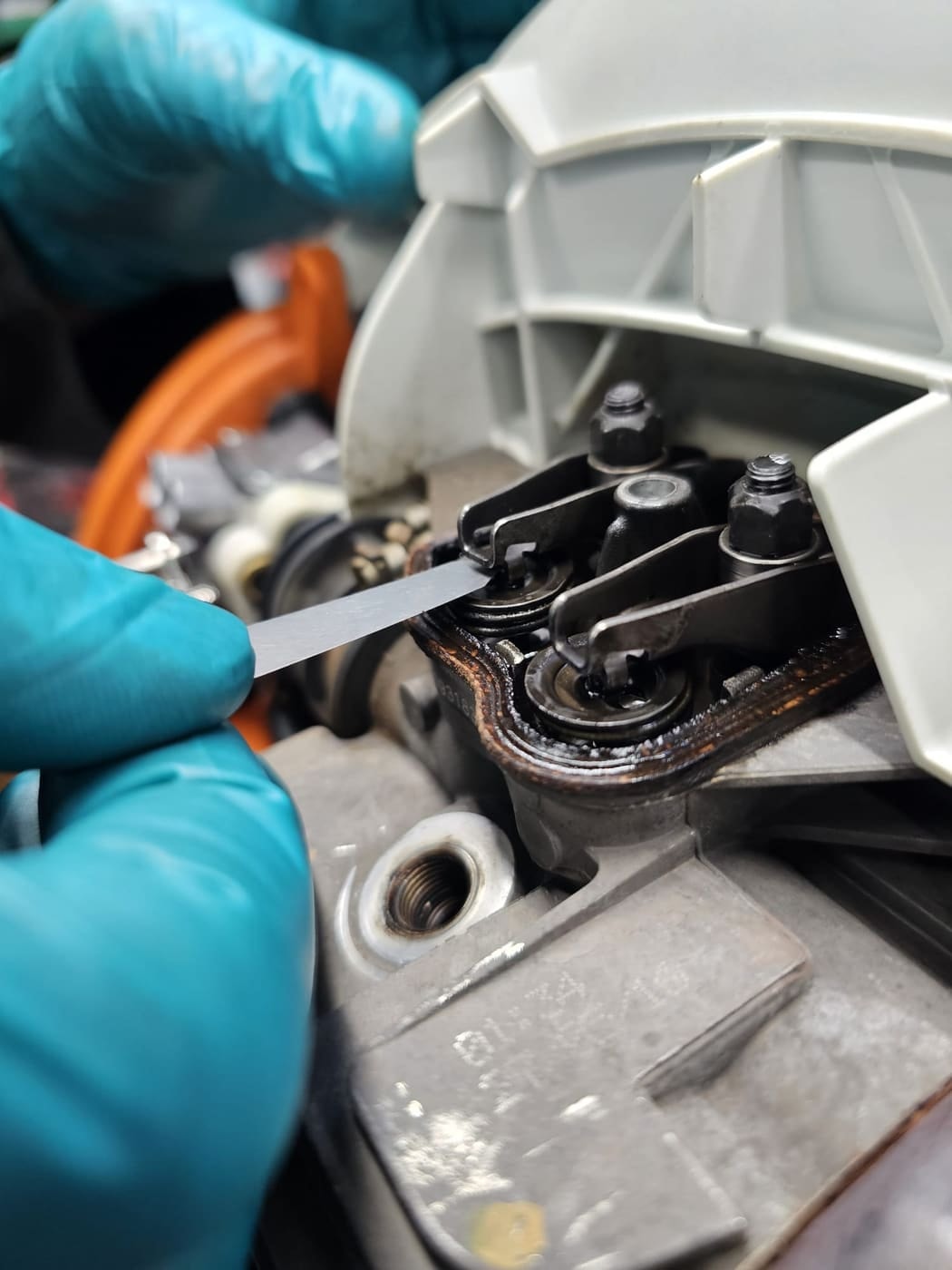 Checking the valve clearance on a STIHL 4-MIX engine with a feeler gauge