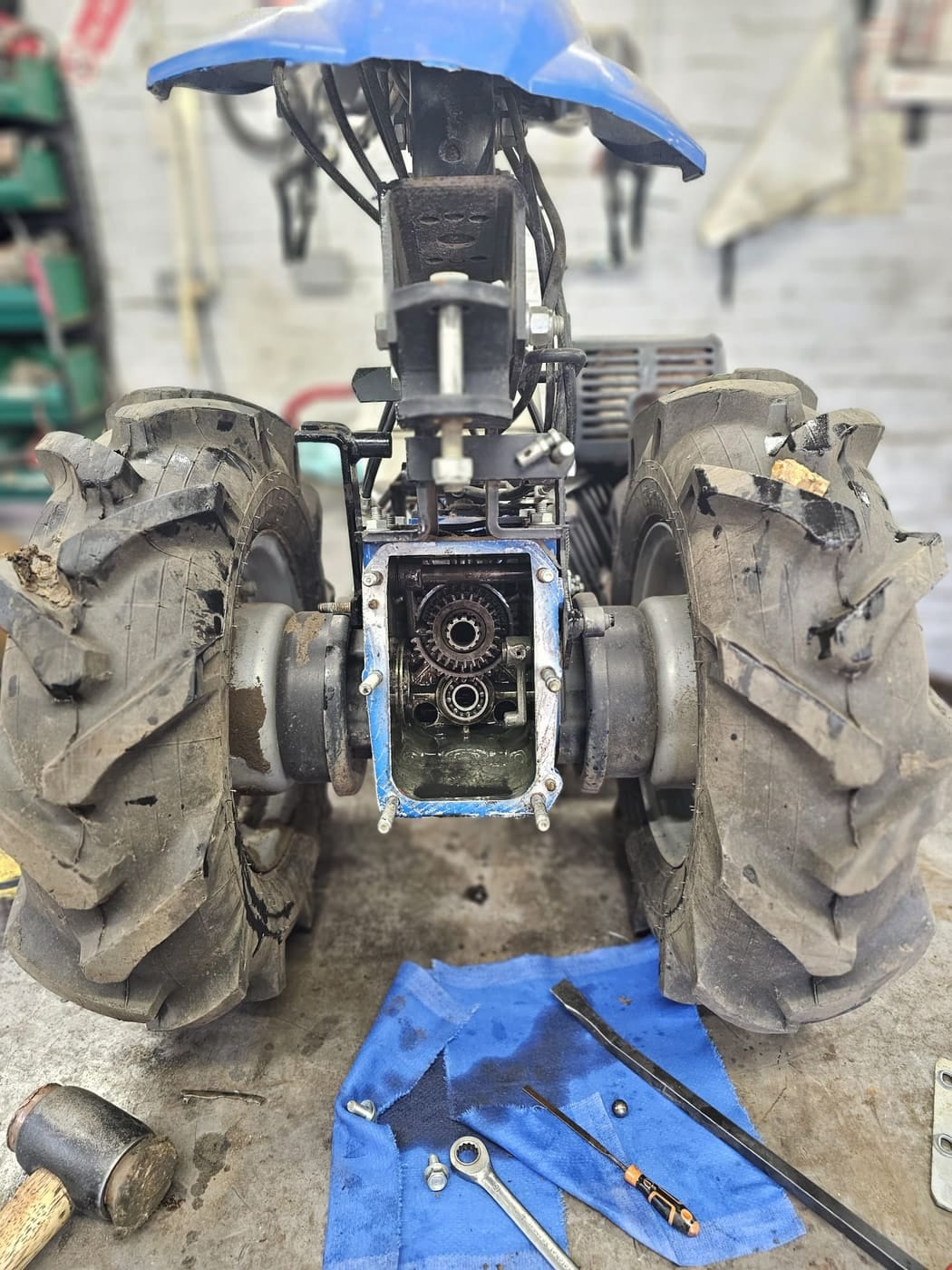A two-wheel tractor with its gearbox cover removed